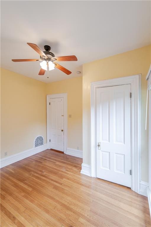 603 N 5th St, Atchison, KS 66002 - unfurnished bedroom featuring light wood-style floors, baseboards, and a ceiling fan