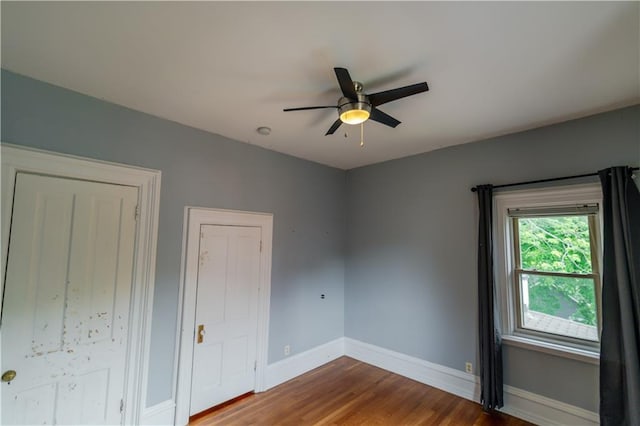 603 N 5th St, Atchison, KS 66002 - empty room featuring baseboards, wood finished floors, and a ceiling fan
