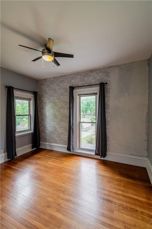 603 N 5th St, Atchison, KS 66002 - empty room with plenty of natural light, light wood finished floors, and baseboards