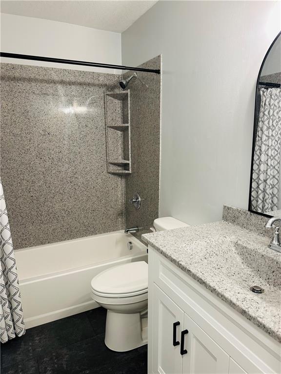 full bathroom featuring vanity, tile patterned floors, shower / bath combo, and toilet