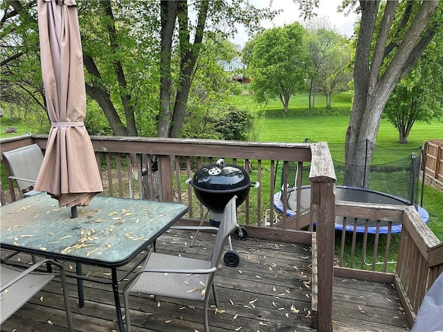 wooden terrace featuring a lawn