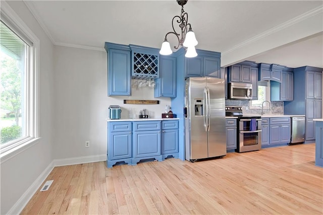 kitchen with visible vents, light wood-style floors, light countertops, blue cabinets, and stainless steel appliances