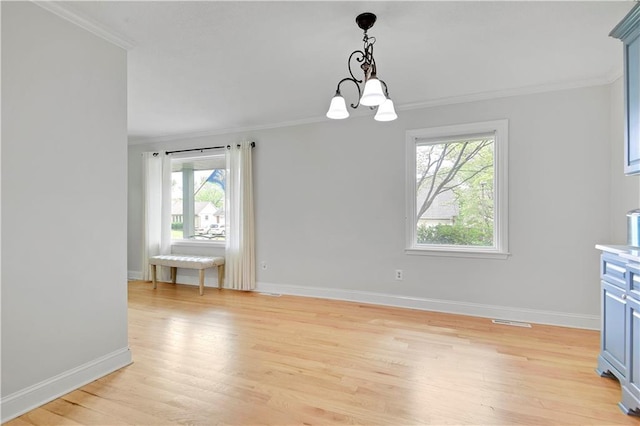 unfurnished dining area with crown molding and light wood-style flooring