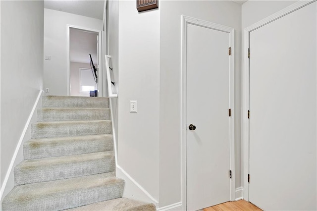 stairway featuring baseboards