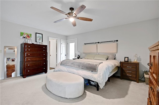 bedroom featuring ceiling fan, light colored carpet, and baseboards