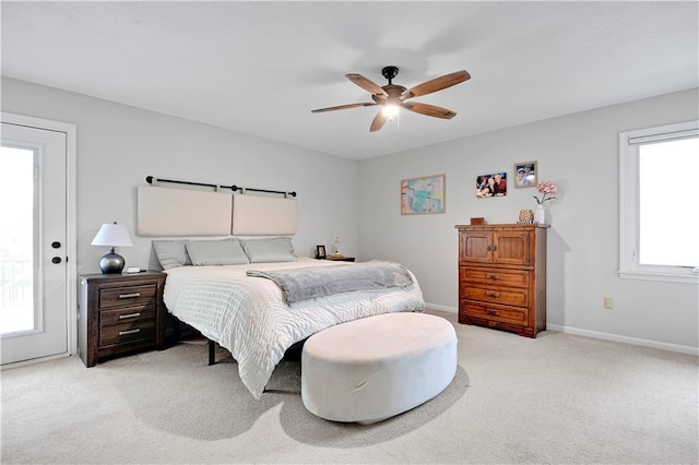 bedroom featuring baseboards, ceiling fan, and light carpet