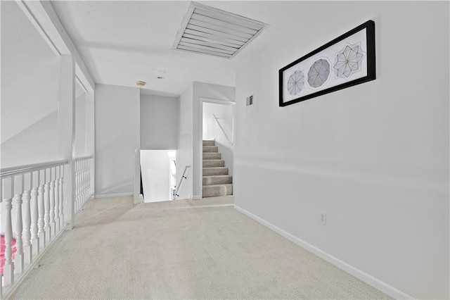 hallway with carpet floors and baseboards