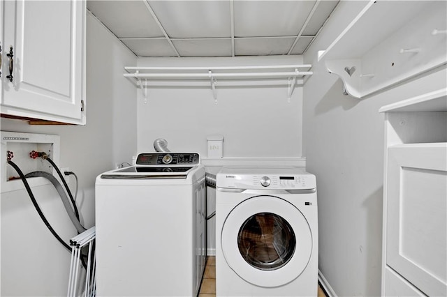 laundry room featuring independent washer and dryer and cabinet space