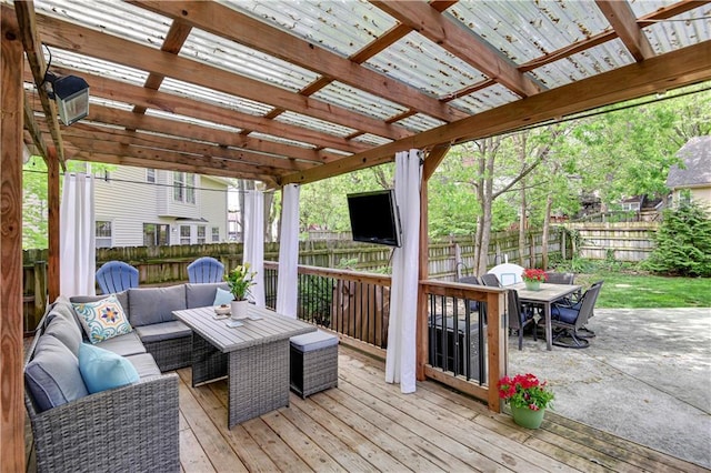wooden terrace featuring an outdoor living space, outdoor dining area, and a fenced backyard