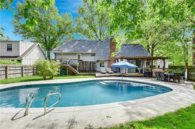 view of pool featuring a fenced in pool, a fenced backyard, and a wooden deck