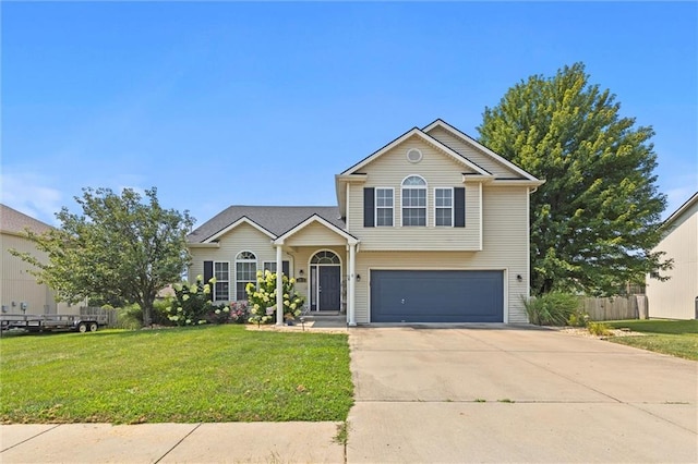 traditional-style house with an attached garage, a front lawn, fence, and driveway