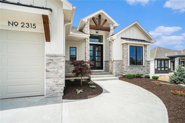 2315 SW Serena Pl, Lees Summit, MO 64082 - view of exterior entry featuring stone siding, board and batten siding, an attached garage, and french doors
