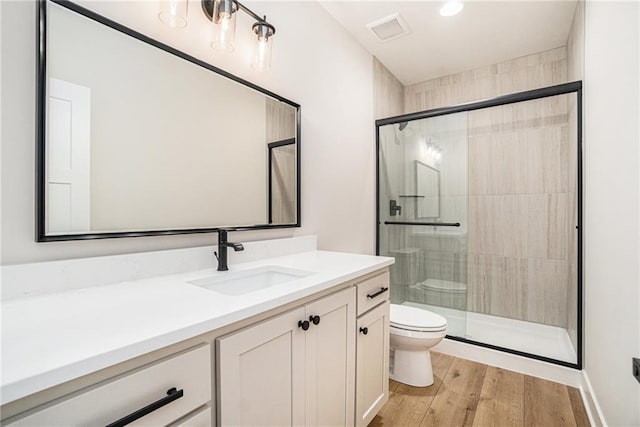 2315 SW Serena Pl, Lees Summit, MO 64082 - full bathroom featuring toilet, vanity, a stall shower, wood finished floors, and recessed lighting