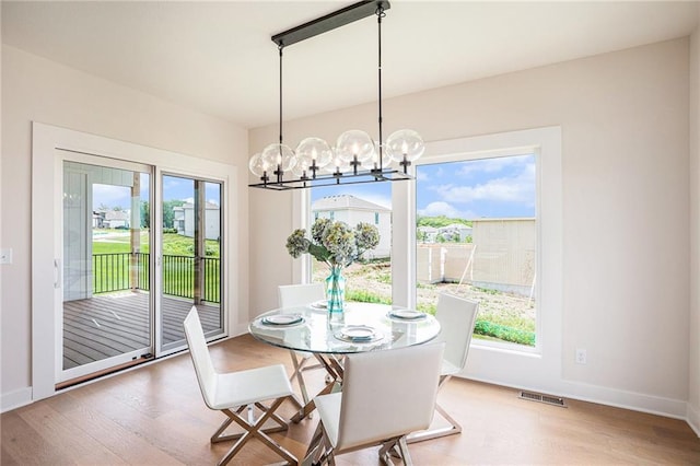 2315 SW Serena Pl, Lees Summit, MO 64082 - dining area featuring wood finished floors and a chandelier