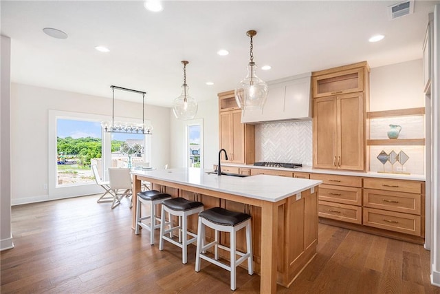 2315 SW Serena Pl, Lees Summit, MO 64082 - kitchen featuring open shelves, an island with sink, decorative backsplash, light countertops, and recessed lighting