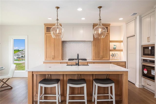 2315 SW Serena Pl, Lees Summit, MO 64082 - kitchen with stainless steel appliances, dark wood-type flooring, light countertops, backsplash, and recessed lighting