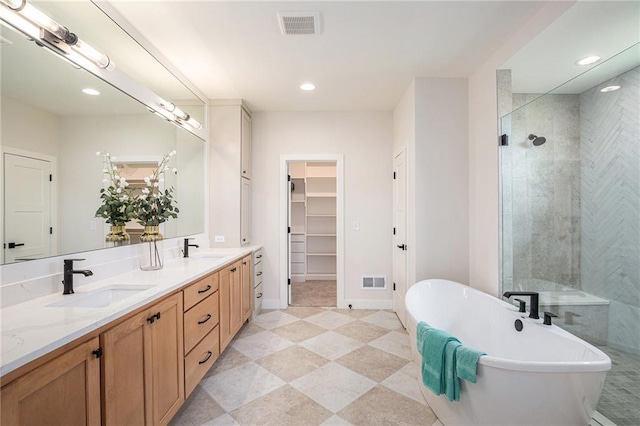 2315 SW Serena Pl, Lees Summit, MO 64082 - full bath with double vanity, a shower stall, a soaking tub, a walk in closet, and recessed lighting