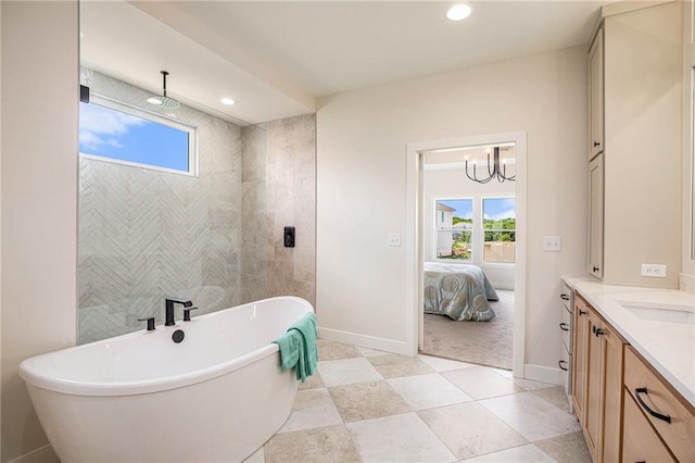 2315 SW Serena Pl, Lees Summit, MO 64082 - ensuite bathroom with vanity, a freestanding tub, healthy amount of natural light, a chandelier, and recessed lighting