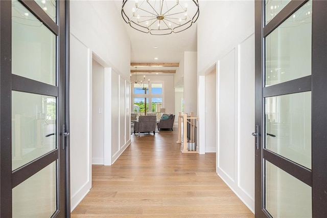 2315 SW Serena Pl, Lees Summit, MO 64082 - corridor with a chandelier and light wood finished floors