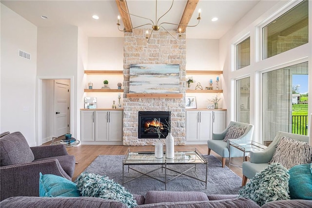 2315 SW Serena Pl, Lees Summit, MO 64082 - living room with light wood-type flooring, a fireplace, a chandelier, and a high ceiling