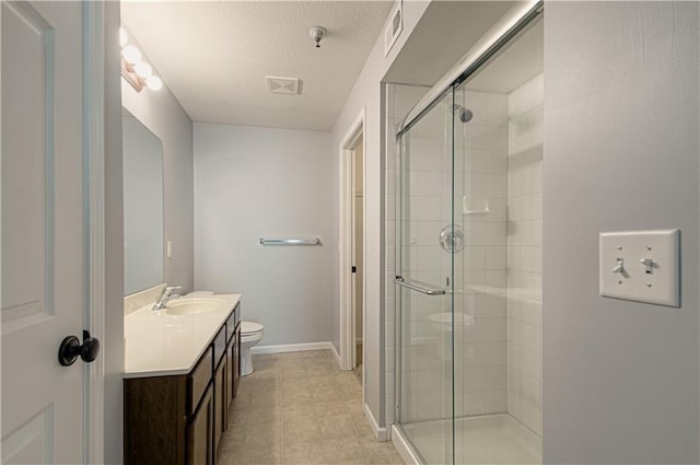 5600 NE 80th Ter Unit 3D, Kansas City, MO 64119 - bathroom with toilet, a stall shower, vanity, a textured ceiling, and baseboards