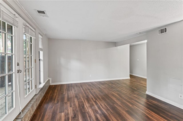 4727 Jarboe St Unit 52, Kansas City, MO 64112 - empty room featuring dark wood-type flooring, baseboards, and a textured ceiling