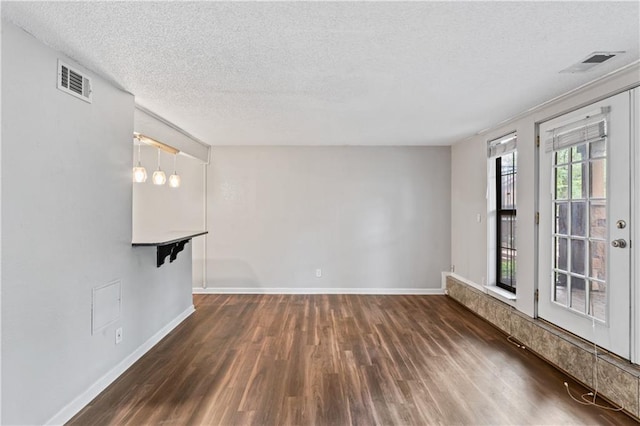 4727 Jarboe St Unit 52, Kansas City, MO 64112 - spare room featuring wood finished floors, a textured ceiling, and baseboards