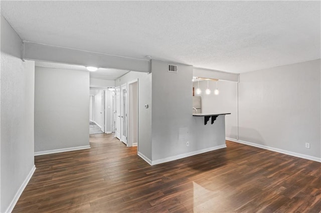 4727 Jarboe St Unit 52, Kansas City, MO 64112 - unfurnished room with dark wood-style flooring, a textured ceiling, and baseboards
