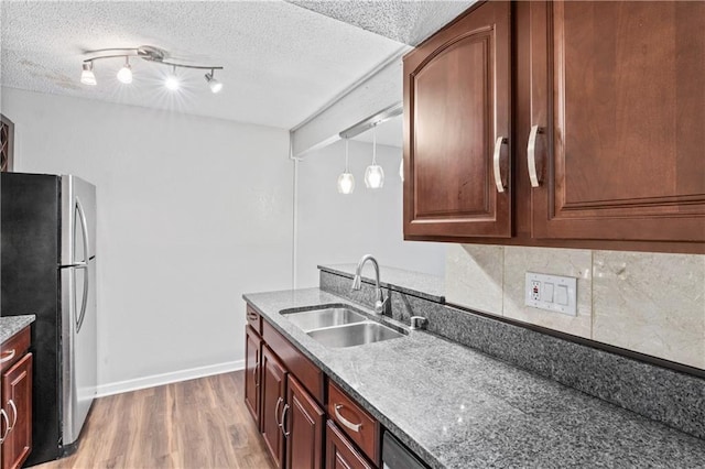 4727 Jarboe St Unit 52, Kansas City, MO 64112 - kitchen featuring freestanding refrigerator, a sink, light wood finished floors, baseboards, and track lighting