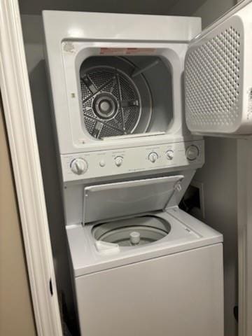 laundry area with stacked washer and dryer and laundry area