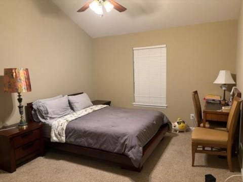 bedroom featuring light colored carpet, vaulted ceiling, and a ceiling fan
