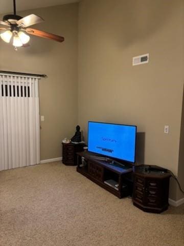 living area with visible vents, carpet flooring, baseboards, and ceiling fan