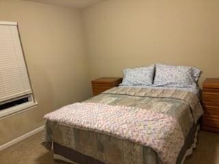 bedroom featuring carpet and baseboards