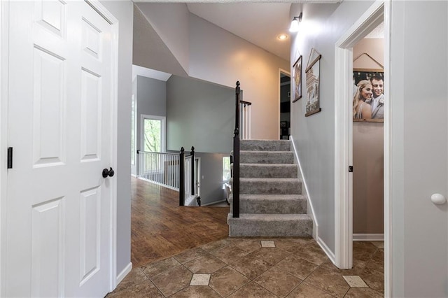 stairway featuring baseboards and recessed lighting