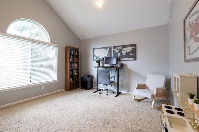 carpeted office with baseboards and high vaulted ceiling