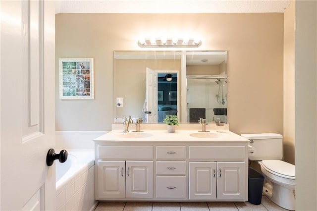 bathroom with toilet, a sink, tile patterned flooring, and a stall shower