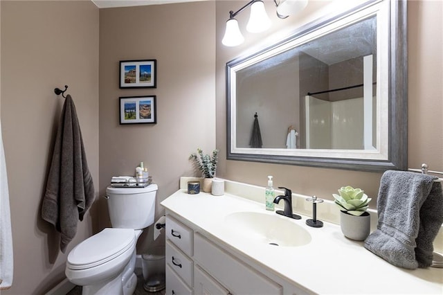 full bath with vanity, toilet, and a shower