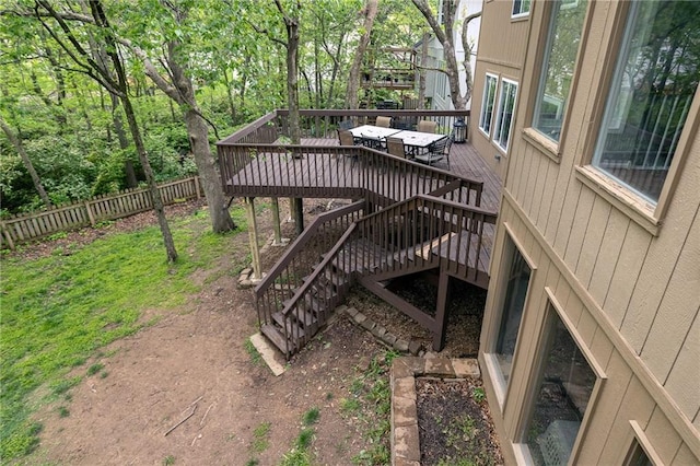 deck with a fenced backyard and stairway