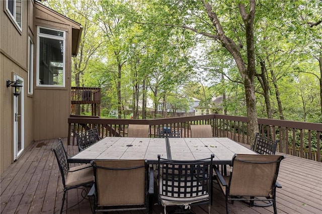wooden terrace featuring outdoor dining area