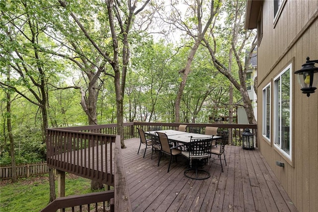 wooden deck featuring outdoor dining area and fence