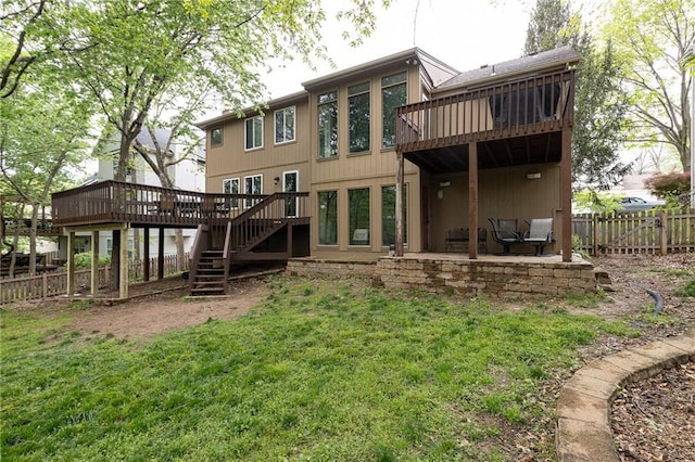 back of house with a fenced backyard, a deck, a yard, and stairway