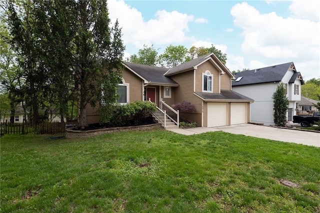 tri-level home with fence, a front lawn, concrete driveway, an attached garage, and stucco siding