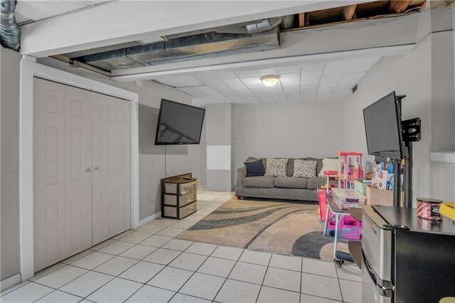 game room with light tile patterned flooring and a drop ceiling