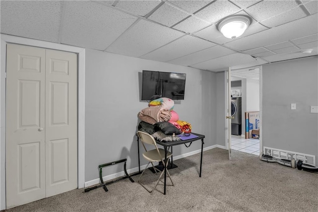 game room with a paneled ceiling, baseboards, carpet floors, and washer / clothes dryer