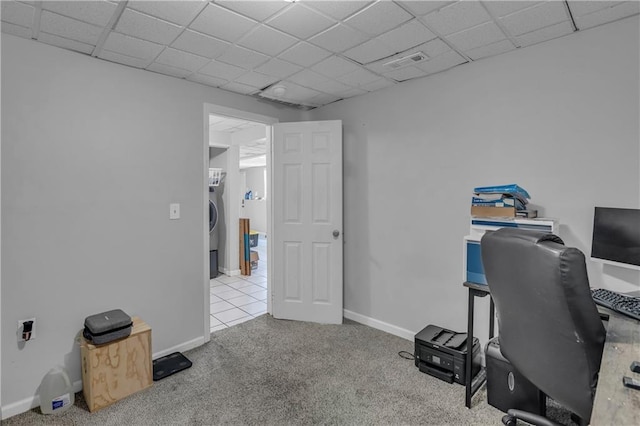 office area with a drop ceiling, visible vents, carpet floors, baseboards, and washer / clothes dryer