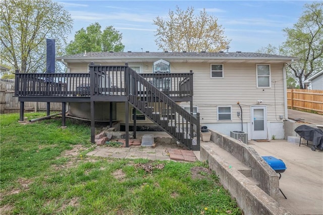 back of property featuring a yard, stairs, fence, and a deck