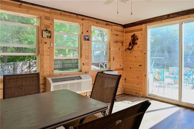 101 W Minor Dr, Kansas City, MO 64114 - dining room with ceiling fan, wood finished floors, wooden walls, and a wall unit AC