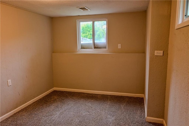 101 W Minor Dr, Kansas City, MO 64114 - carpeted spare room featuring baseboards, a textured ceiling, and a textured wall