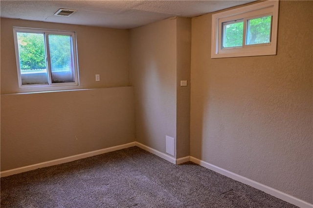 101 W Minor Dr, Kansas City, MO 64114 - spare room with baseboards, a textured wall, and carpet