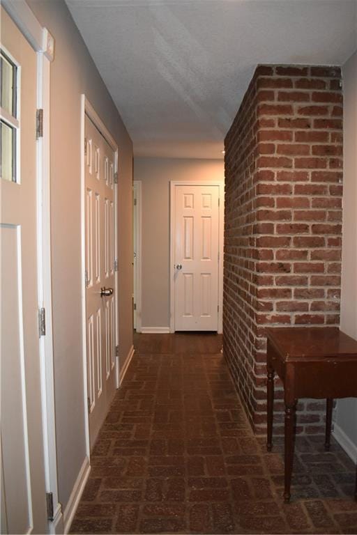 101 W Minor Dr, Kansas City, MO 64114 - corridor featuring baseboards and brick flooring